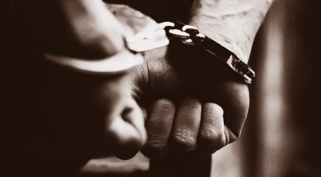 man's hands in handcuffs